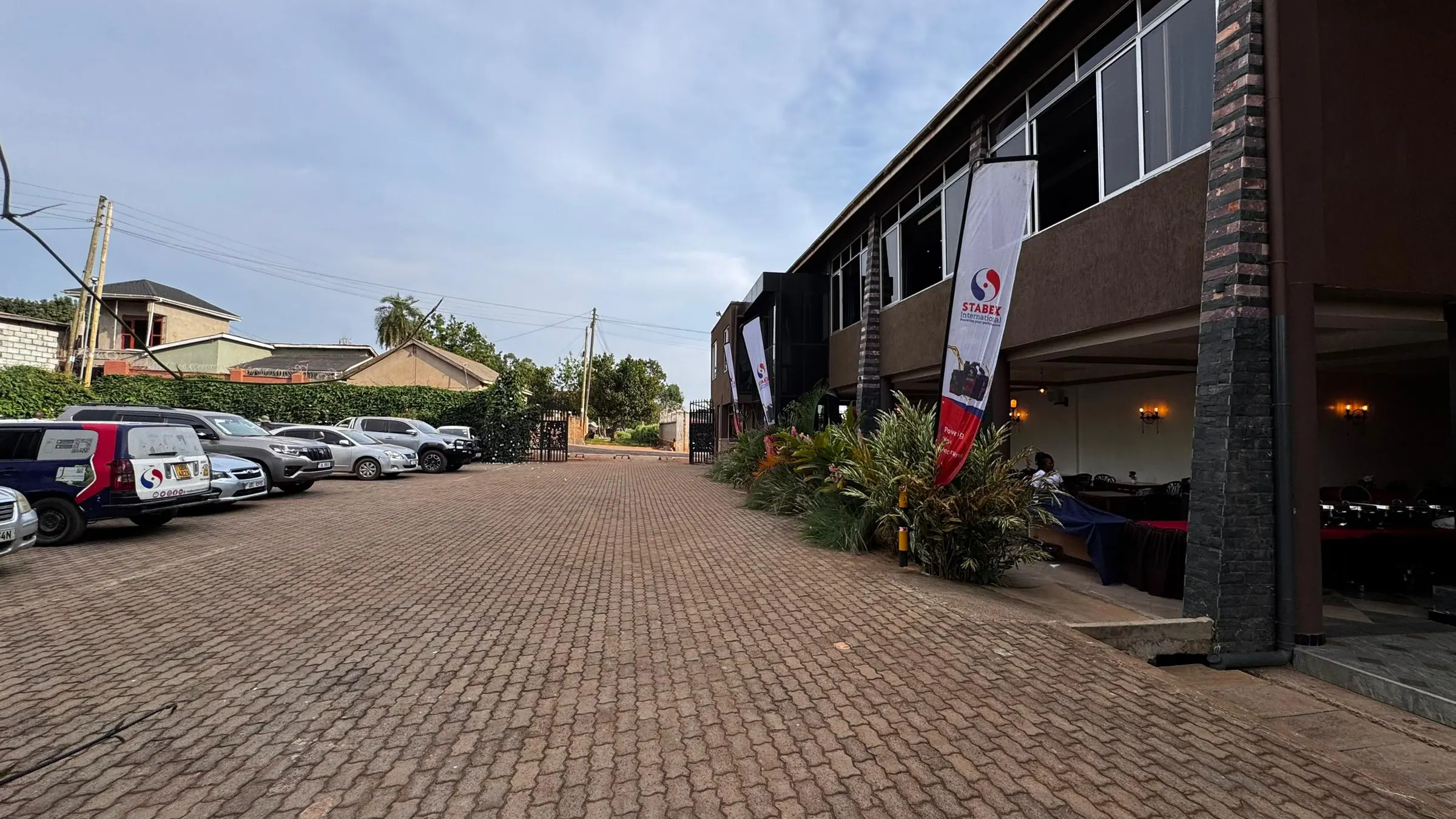 The exterior of Nexus Resorts Hotel Plus with parking in the foreground